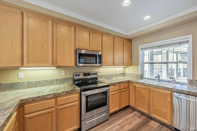 kitchen with appliances with stainless steel finishes, light brown cabinetry, sink, light hardwood / wood-style floors, and crown molding