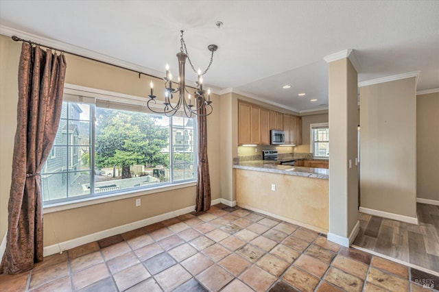 kitchen with hanging light fixtures, stainless steel appliances, ornamental molding, a chandelier, and light brown cabinets