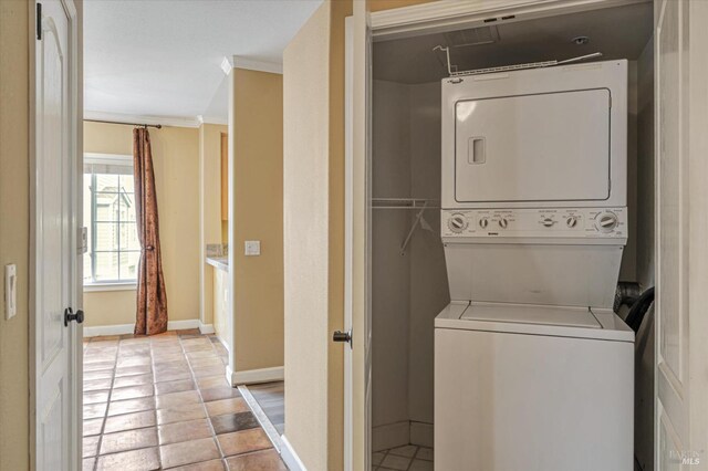 852 Diablo Ave Unit 110, Novato, CA 94947 - washroom featuring stacked washer / drying machine, crown molding, baseboards, and light tile patterned flooring