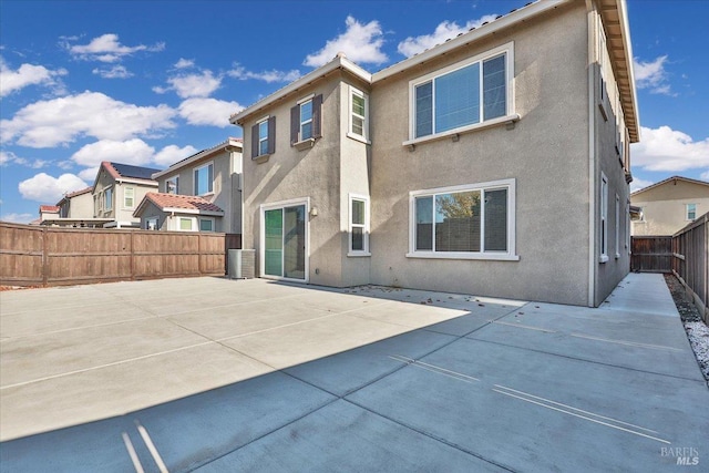 rear view of property featuring a patio and central air condition unit