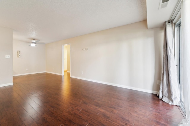 spare room with ceiling fan, dark hardwood / wood-style floors, and a textured ceiling