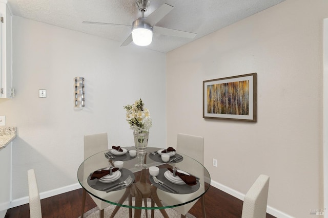 dining room with ceiling fan, hardwood / wood-style flooring, and a textured ceiling