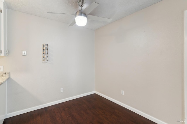 spare room featuring ceiling fan, hardwood / wood-style flooring, and a textured ceiling