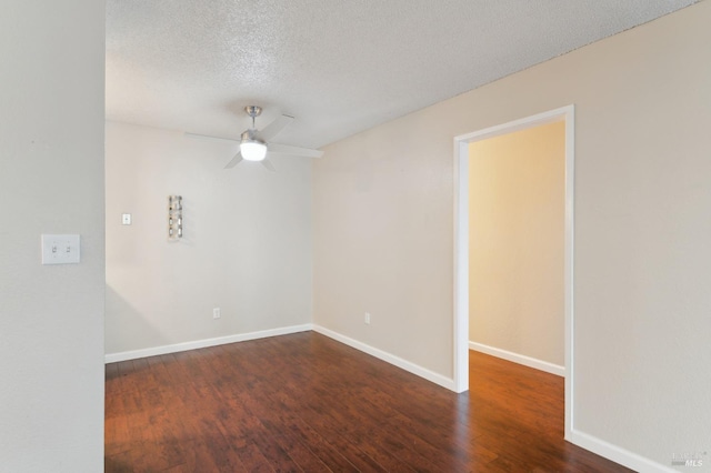 empty room with dark hardwood / wood-style flooring, ceiling fan, and a textured ceiling