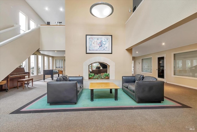 building lobby featuring a wealth of natural light, a high ceiling, and carpet