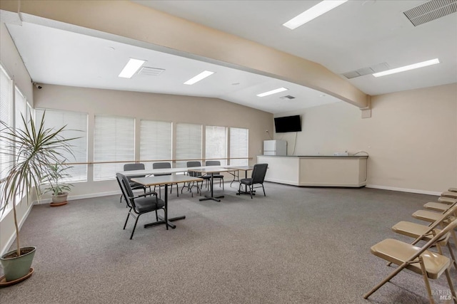 dining space with lofted ceiling with beams and carpet