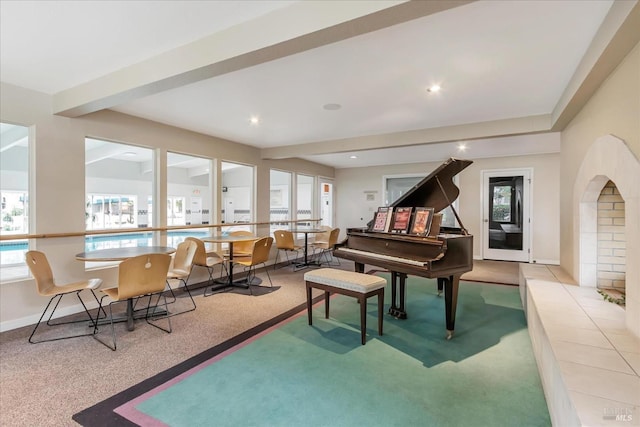 living area with carpet flooring and beam ceiling