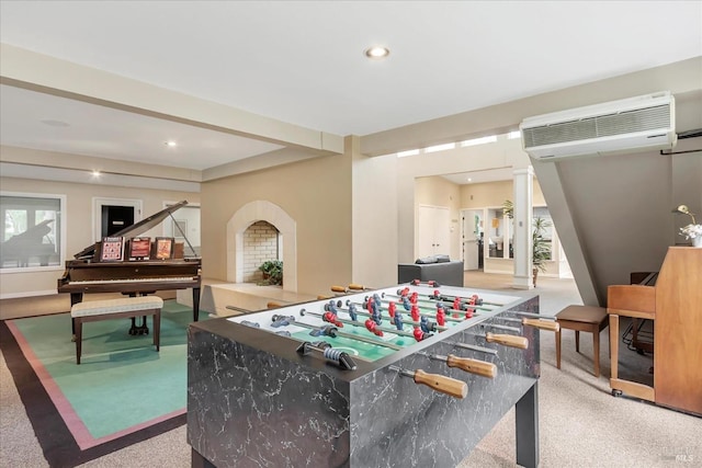 recreation room with light carpet and a wall unit AC