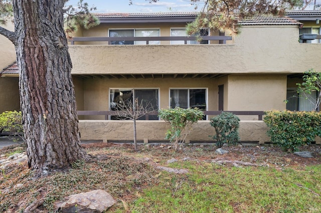 rear view of house featuring a balcony