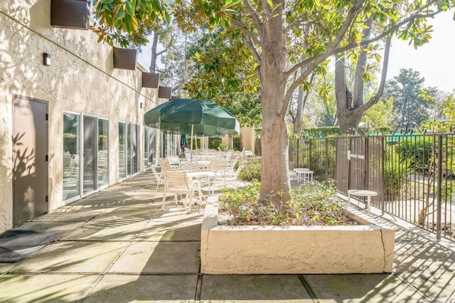 view of property's community with a patio area