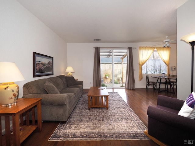 living room with ceiling fan and dark hardwood / wood-style floors