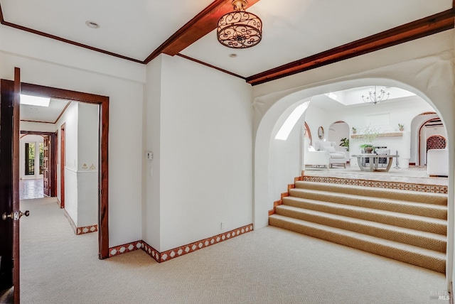 107 Deer Hollow Rd, San Anselmo, CA 94960 - stairway with arched walkways, carpet flooring, crown molding, baseboards, and a chandelier