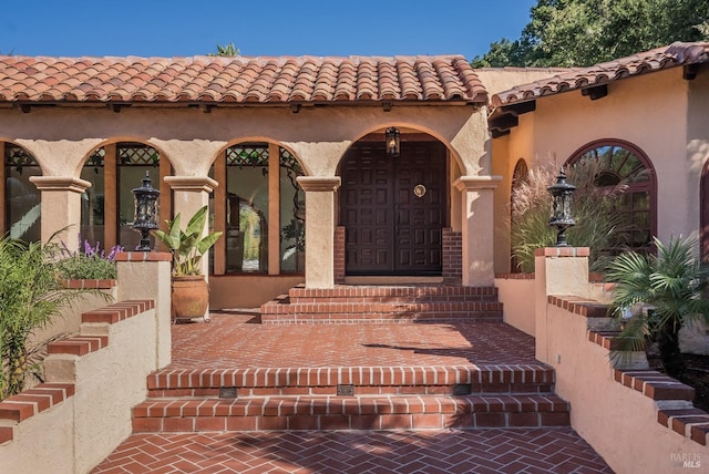 107 Deer Hollow Rd, San Anselmo, CA 94960 - view of exterior entry featuring a tile roof and stucco siding