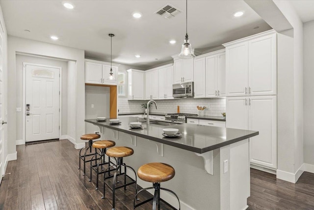 kitchen featuring sink, stainless steel appliances, and white cabinets