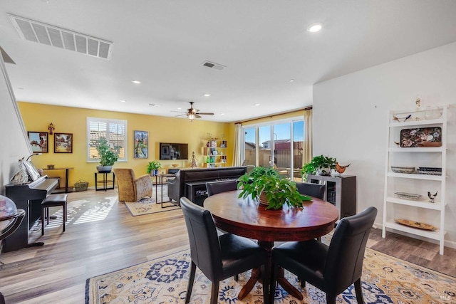 dining area featuring ceiling fan and light hardwood / wood-style floors