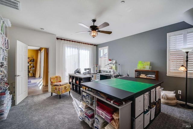 rec room with dark colored carpet and ceiling fan