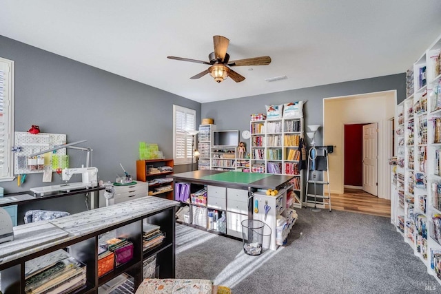 playroom with carpet and ceiling fan