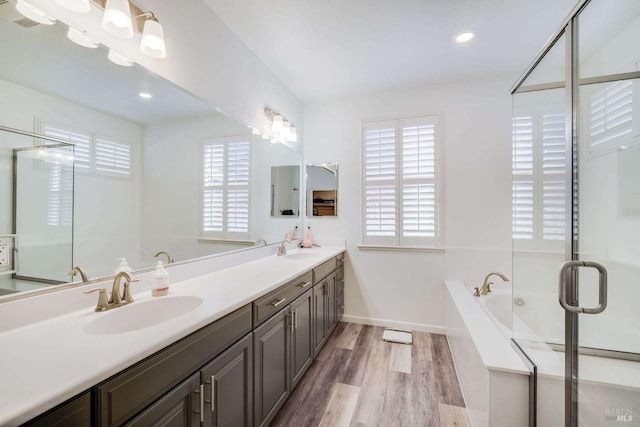 bathroom featuring independent shower and bath, vanity, and hardwood / wood-style floors