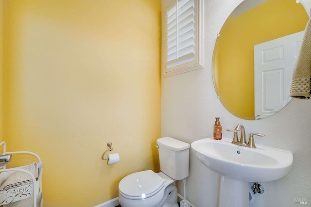 bathroom with toilet and sink