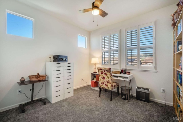 office area with ceiling fan and dark colored carpet