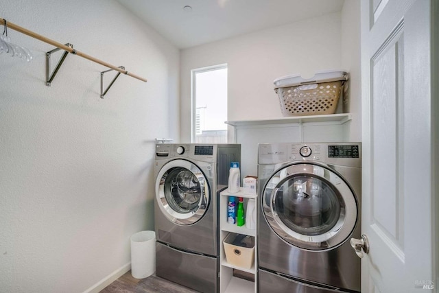 washroom with hardwood / wood-style floors and washer and clothes dryer