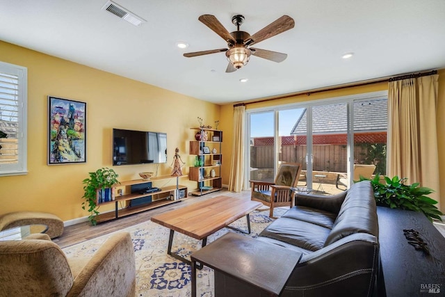 living room with ceiling fan and hardwood / wood-style floors