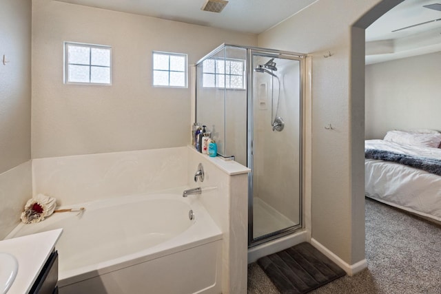 bathroom with ceiling fan, vanity, and separate shower and tub