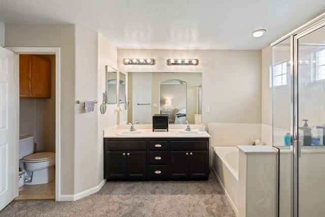 full bathroom with plus walk in shower, vanity, a textured ceiling, and toilet