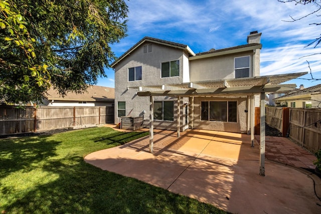 back of property featuring a pergola, a patio area, and a lawn