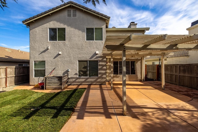 rear view of house featuring a patio, a lawn, and a pergola