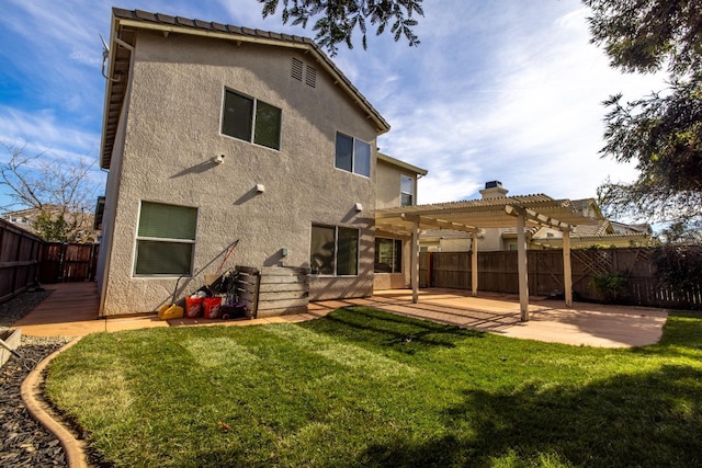 back of property with a yard, a patio area, and a pergola