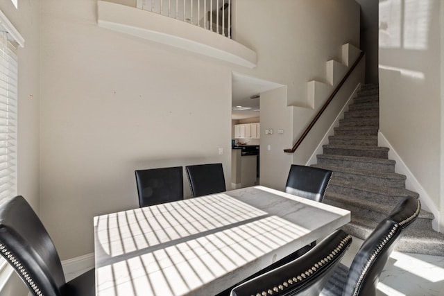 dining space with a towering ceiling