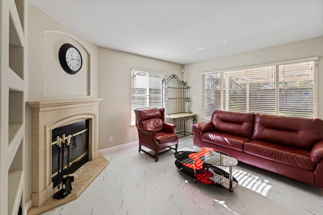 living room featuring a high end fireplace