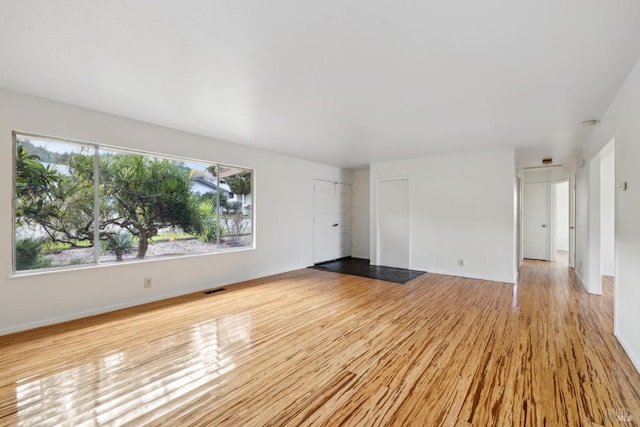 spare room featuring light hardwood / wood-style floors