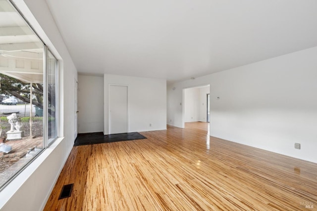 unfurnished room with hardwood / wood-style flooring