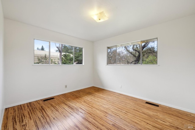 spare room with wood-type flooring