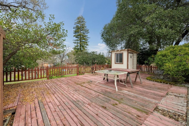 wooden terrace with a storage shed