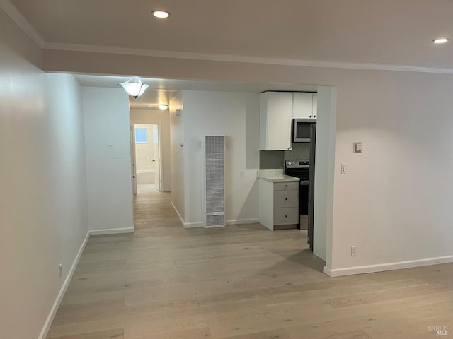 corridor featuring crown molding and light hardwood / wood-style floors