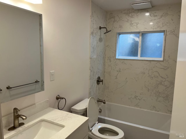 full bathroom with vanity, tiled shower / bath combo, and toilet