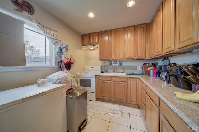 kitchen featuring sink, white electric range, and light tile patterned flooring