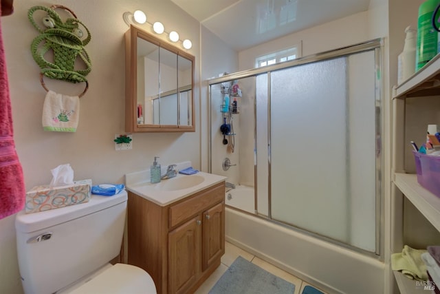 full bathroom featuring tile patterned flooring, vanity, shower / bath combination with glass door, and toilet