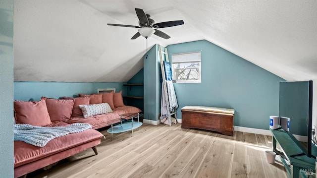 bonus room with lofted ceiling, a textured ceiling, wood finished floors, a ceiling fan, and baseboards