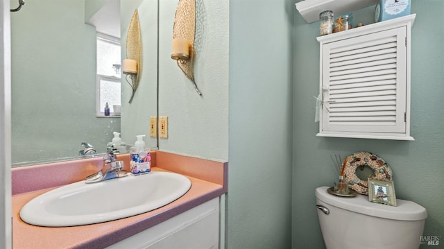 half bathroom with toilet and vanity