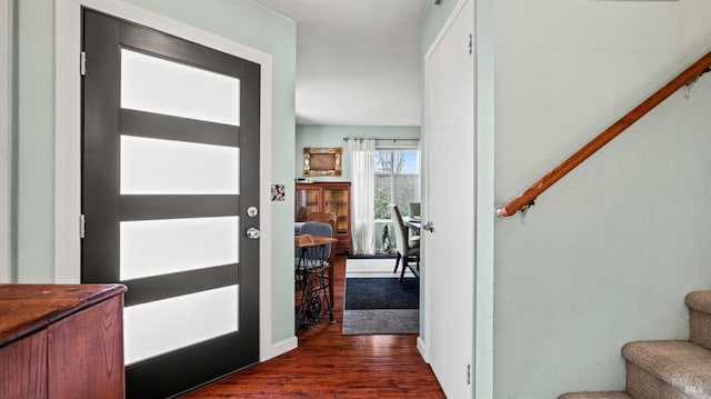 foyer entrance featuring dark wood-style flooring and stairs