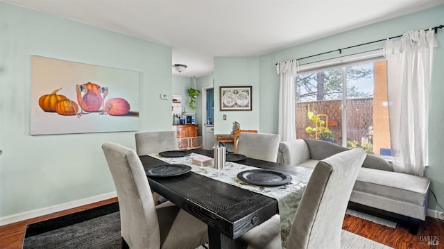 dining room featuring wood finished floors and baseboards