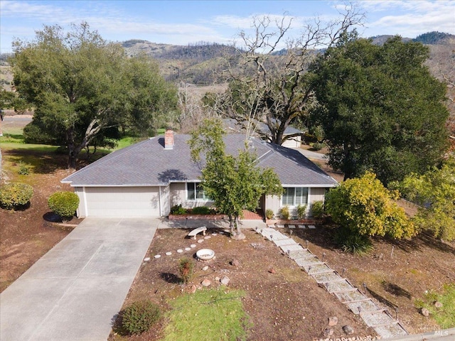 view of front of home featuring a garage and a mountain view