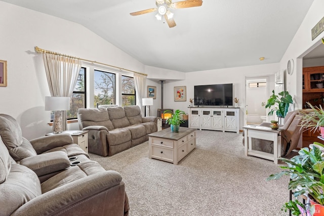 carpeted living room with ceiling fan and lofted ceiling