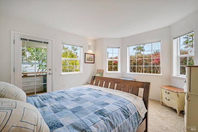 carpeted bedroom featuring access to outside