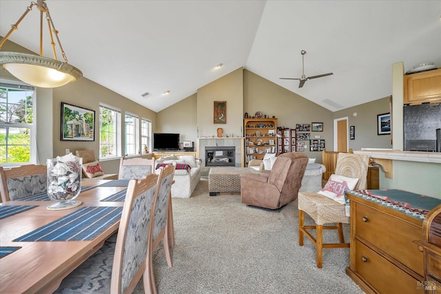 carpeted dining room featuring high vaulted ceiling and ceiling fan