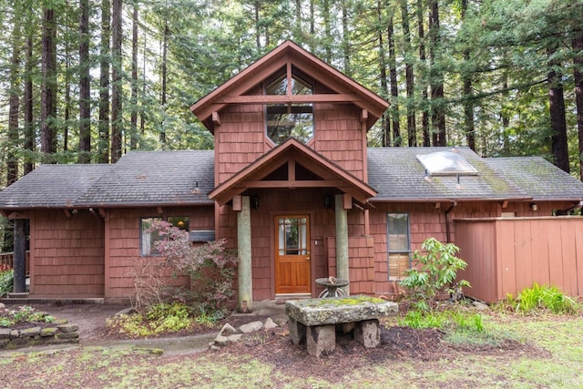 chalet / cabin with a shingled roof